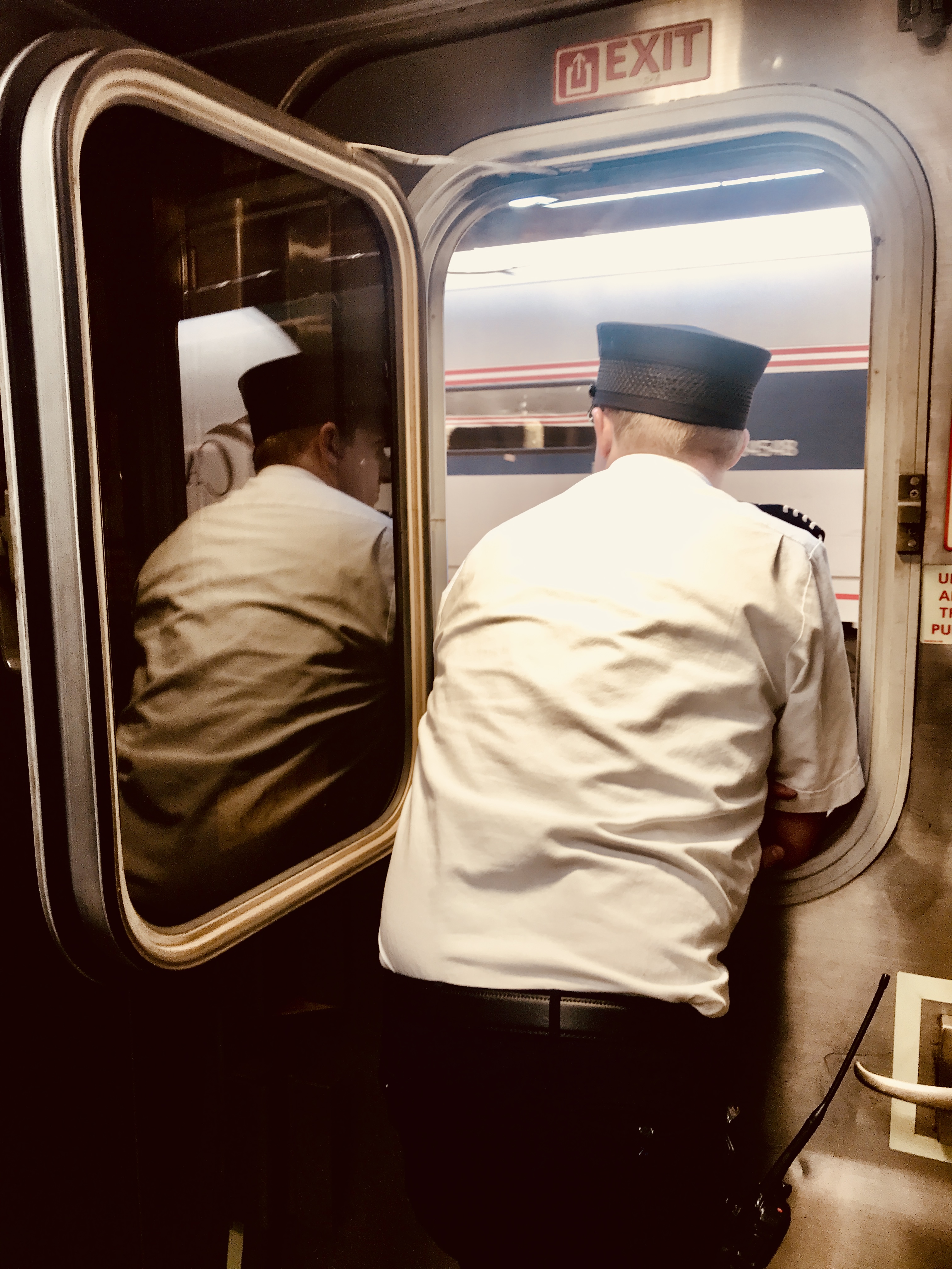 photograph of a train conductor looking out the window of a train