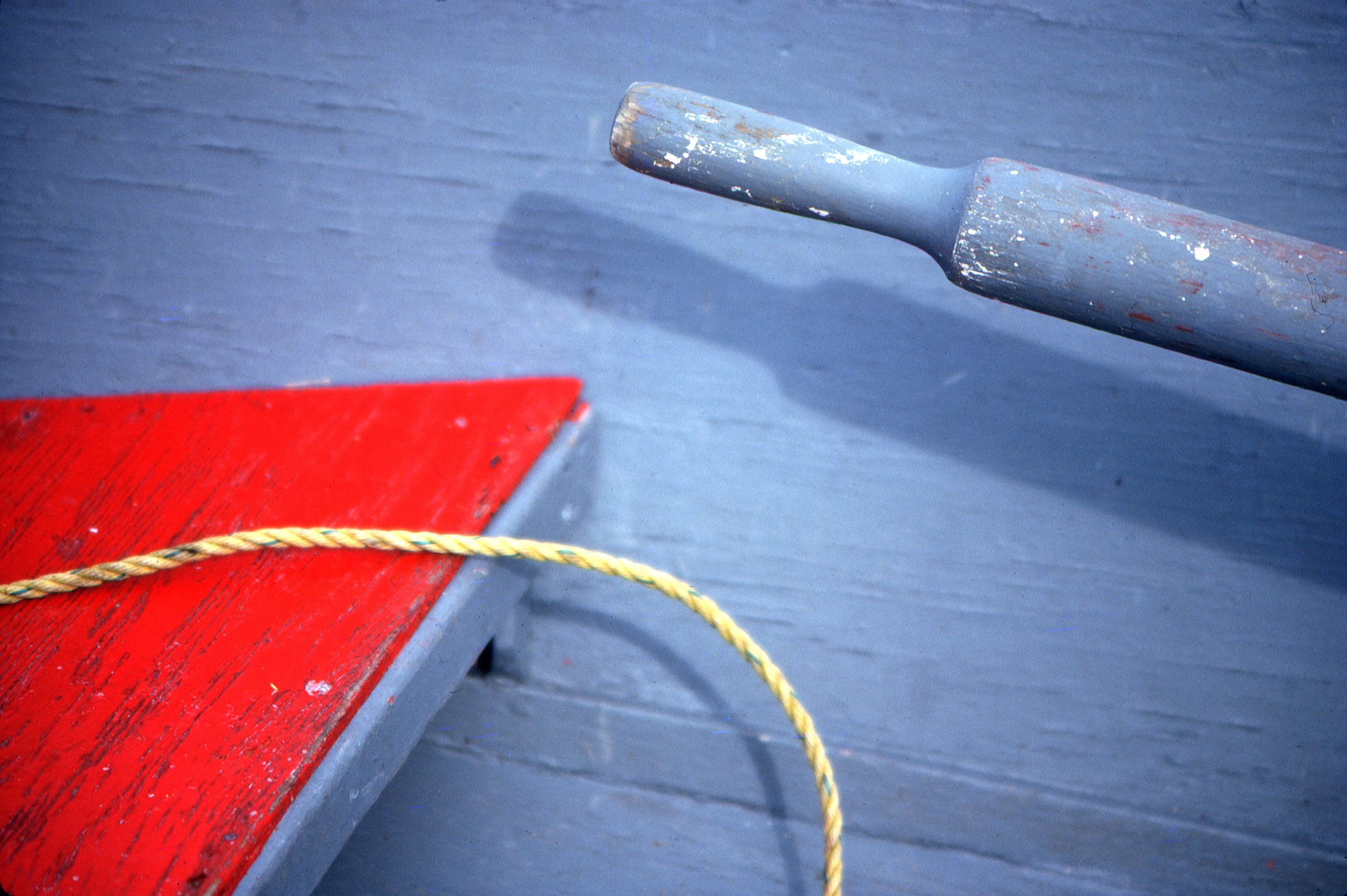 photograph of an oar and rope in a rowboat